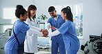 Hospital, nurses and doctor with hands together for huddle, teamwork or motivation in clinic. People, employees or healthcare professionals with stack for medical solidarity, collaboration or support
