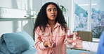 Woman, nurse and patient with water or medication for medical cure or symptoms in clinic. Female person, doctor and giving client pills with mineral liquid for diagnosis or antibiotic in hospital