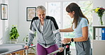 Elderly woman, wheelchair or walking with physiotherapist on rail for balance or mobility in clinic. Senior, patient or physio helping person with a disability for movement, steps or muscle recovery