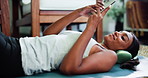 Home, relax and woman with smartphone, exercise and typing with subscription, sound and app. Apartment, break and cellphone on floor, fitness and streaming audio with radio, podcast and social media 