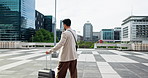 Businessman, travel and moving with suitcase in city for business commute, work or destination. Man, traveler or employee with luggage for corporate migration or new opportunity in an urban town