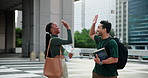 Happy student, friends or winning with high five or books in city for education, learning or success. Man, woman or academic people with textbooks, smile or achievement for studying in an urban town