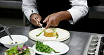 Culinary, plating or hands in restaurant with tweezers, catering or presentation in luxury cuisine. Hospitality, man or chef in kitchen with tool, dinner preparation or food decorating in fine dining