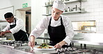 Chef, plating and woman with dish, kitchen and culinary skills for food presentation, order and meal. Restaurant, cook and person with cloth for smudge removal, hospitality and cuisine preparation