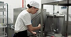 Washing dishes, cleaning and restaurant with woman in kitchen as dishwasher, sanitary and hospitality. Scullery worker, hygiene and bacteria protection with person in cafe for food safety policy