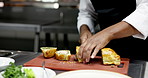Hands, chef and cutting beef wellington in restaurant kitchen, catering service and meal order. Person, cooking and cuisine for food on board with culinary skills, gourmet dish and pastry at diner