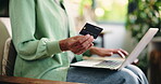 Credit card, laptop or hands in home for online shopping, check info or typing numbers for digital purchase. Transaction, ecommerce or person with fintech for banking, checkout or payment process 