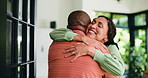 Love, couple and hug in home for reunion, support and talk to interracial partner for trust. Embrace, happy man and mature woman in house for welcome back, greeting or connection for marriage by door