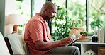 Reading, relax or black man in home with tablet, personal development blog or search online for self help ebook. Peace, browsing internet or person with tech for learning, goal setting forum or app