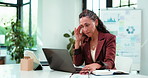 Data, laptop and stress with business woman at desk in office for planning, report or research. Anxiety, burnout and computer with mature employee in workplace for review of charts of graphs