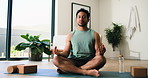 Calm man, yoga and inner peace with meditation in home for spiritual wellness or mental wellbeing. Male person, relax or zen with lotus for breathing exercise, awareness or mindfulness in house