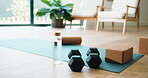 Empty, indoor and equipment for pilates at house for exercise, training and morning routine. Setup, dumbbells and foam block with water bottle, physical activity and workout weights for wellness