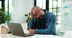 Data, laptop and stress with business black man at desk in office for planning, report or research. Anxiety, burnout and computer with mature African employee at work for review of charts of graphs