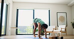 Active, fitness and jump with man in living room of home for development, training or workout. Burpees, exercise and wellness with person on floor in apartment for commitment or dedication or health