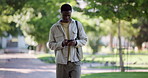 Student, man and walking with phone at college for study break, text message or online notifications. Education, black person or smartphone outdoor for university portal, check results or scholarship