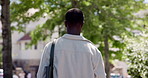 Back, student and black man in city, walking and travel with urban town, scholarship and university. Outdoor, commute and African person with higher education, college and pedestrian with gen z