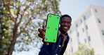 Hands, phone and green screen in city, outdoor and mockup space with low angle for travel application. Person, smartphone and ui display for user experience, tourism and happy in town on vacation