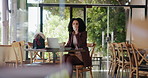 Woman, typing and drinking coffee in cafe with laptop for remote work, journalism idea and news report. Freelancer, person and beverage in restaurant with computer, editing article, blog and review.