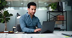 Man, laptop and project at startup with review, documents and typing with report at media company. Person, computer and insight for web traffic, feedback or stats with paperwork at creative agency