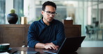 Business, man and reading with laptop in office for research, finance report and review budget. Thinking, male person and glasses with pc for financial email, problem solving and ideas for investment
