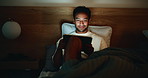 Evening, bedroom and man with tablet, reading and search for funny blog, humor and ebook. Doom scroll, night or person with tech, laughing or blue light exposure with app for social media or home