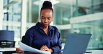 Laptop, documents and black woman with reading for finance review, research or analytics. Office, tech and business person with typing, graph or report for financial planning, audit or project budget