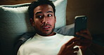 Man, phone and aroused in bed for temptation, self pleasure and masturbation in home. Night, secret and person with smartphone for pornography, addiction and sneaky activity in bedroom of apartment