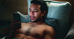 Man, phone and internet in bed for temptation, self pleasure and masturbation in home. Night, secret and person with smartphone for pornography, addiction and sneaky activity in bedroom of apartment