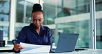Laptop, paperwork and black woman with reading for finance review, research or analytics. Office, tech and business person with typing, graph or report for financial planning, audit or project budget