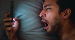 Night, tired man and yawn in bed with phone for social media, entertainment and online communication. Late, exhausted person and sleepy in house with tech for mobile app, text message and eye strain.
