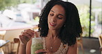 African woman, stirring and drink at cafe with iced matcha latte, refreshing smoothie and mix flavor. Smile, female person and green milkshake for healthy beverage, nutrition benefits and weight loss