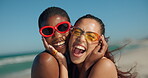 Friends, hug and women with sunglasses, beach or excited for summer vacation, happiness and together. Outdoor, diversity and people with support on holiday, bonding and laugh in nature, break or sea