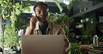 Phone call, computer and black man in plant nursery with communication for online order. Happy, laptop and African male botanist on mobile discussion for ecology advice or feedback at garden center.