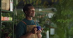 Nursery, plants and black man with drink in store for environment, greenhouse and gardening. Thinking, small business and person with coffee, beverage and calm for leaves, planting and sustainability