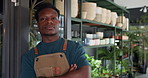 Nursery, plants and black man in store thinking for small business, greenhouse and gardening sale. Crossed arms, idea and person with pots, leaves and shelves for growth, planting and sustainability