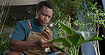 Serious florist, man and photo of plant in shop to monitor health, growth app or leaf damage. Sustainable small business, confused black person or picture research for unhealthy development or review