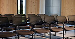 Chairs, convention and empty room for business forum, event and seminar with meeting venue. Furniture, hall and interior at conference center with rows for summit, presentation and seats for workshop