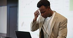 Data, laptop and sweating with black man speaker on stage in auditorium for seminar or workshop. Computer, projection screen and tissue with nervous employee at podium for presentation of statistics