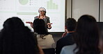 Conference, chart and presentation with business woman at event for broker workshop, public speaking and seminar. Lecture, convention and tradeshow expo with employees at summit for investor data