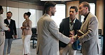 Businessmen, discussion and handshake in conference, networking and unity for global trade at event. Group, talking and shaking hands for foreign investment, agreement and partnership for venture