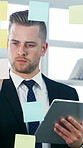 Glass wall, sticky notes and tablet with business man in office for brainstorming or planning. App, schedule and storyboard with corporate employee in professional workplace for strategy development