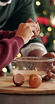 Christmas, helping hand or child in kitchen with baking, egg crack or bonding in holiday season. Festive, bokeh or family in house with learning, support or dessert preparation in December tradition.