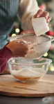 Festive, helping hand or kid in kitchen with flour, baking support or bonding in holiday season. Christmas, learning or child in home with ingredients, connection or dessert prep in cooking tradition