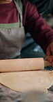 Hands, child and dough at house for Christmas holiday, rolling pastry and bonding together. Closeup, kid and dessert preparation for sweet treats, festive tradition and celebration with xmas cookies