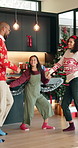 Celebration, Christmas and dance with family in kitchen of home together for festive tradition. Holidays, music or rhythm with excited mother, father and daughter in apartment for December season
