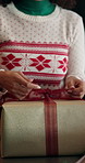 Woman, hands and wrapping box with christmas gift for santa present or december holiday in home. Closeup, female person or preparation with ribbon or package for festive celebration or tradition