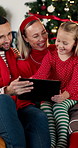 Christmas, laughing and tablet with family on sofa in living room of home for festive celebration. App, conversation or streaming with funny mom, dad and daughter in apartment for holiday planning