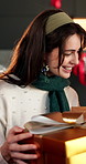 Christmas, woman and excited in home with gifts, gratitude and smile for festive bonding together. Family, apartment and Xmas with people, presents and giving for holiday season and happy tradition