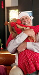 Hug, Christmas and grandfather with child on sofa for festive holiday, celebration and support. Love, happiness and reunion with senior man and girl in living room of family home for xmas season