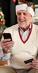 Credit card, Christmas and mature man in home with phone for online shopping with festive season deals. Fintech, cellphone and male person with ecommerce for xmas discount and purchase in house
